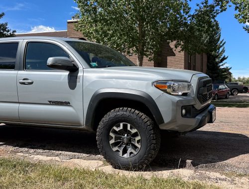 A Toyota Tacoma pickup truck parked outdoors, viewed from the front three-quarter angle