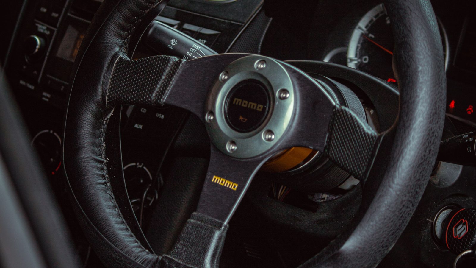 Close-up shot of a black steering wheel