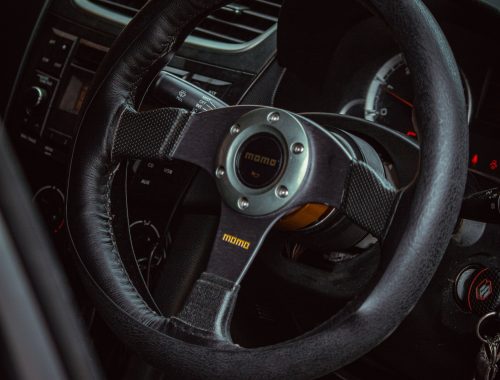 Close-up shot of a black steering wheel