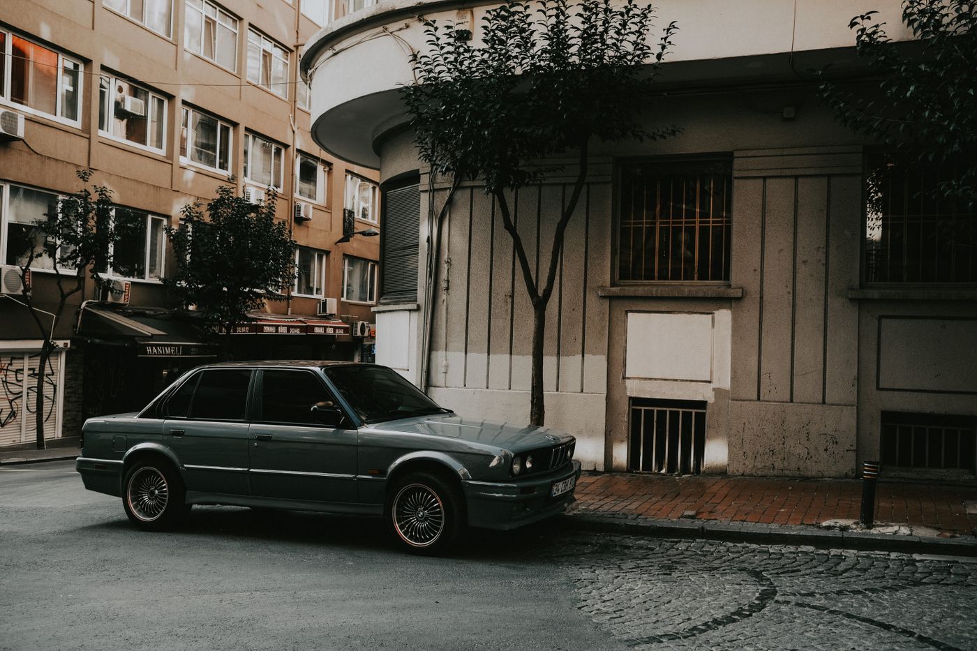 Vintage BMW parked on a street, showing the classic blue and white roundel badge