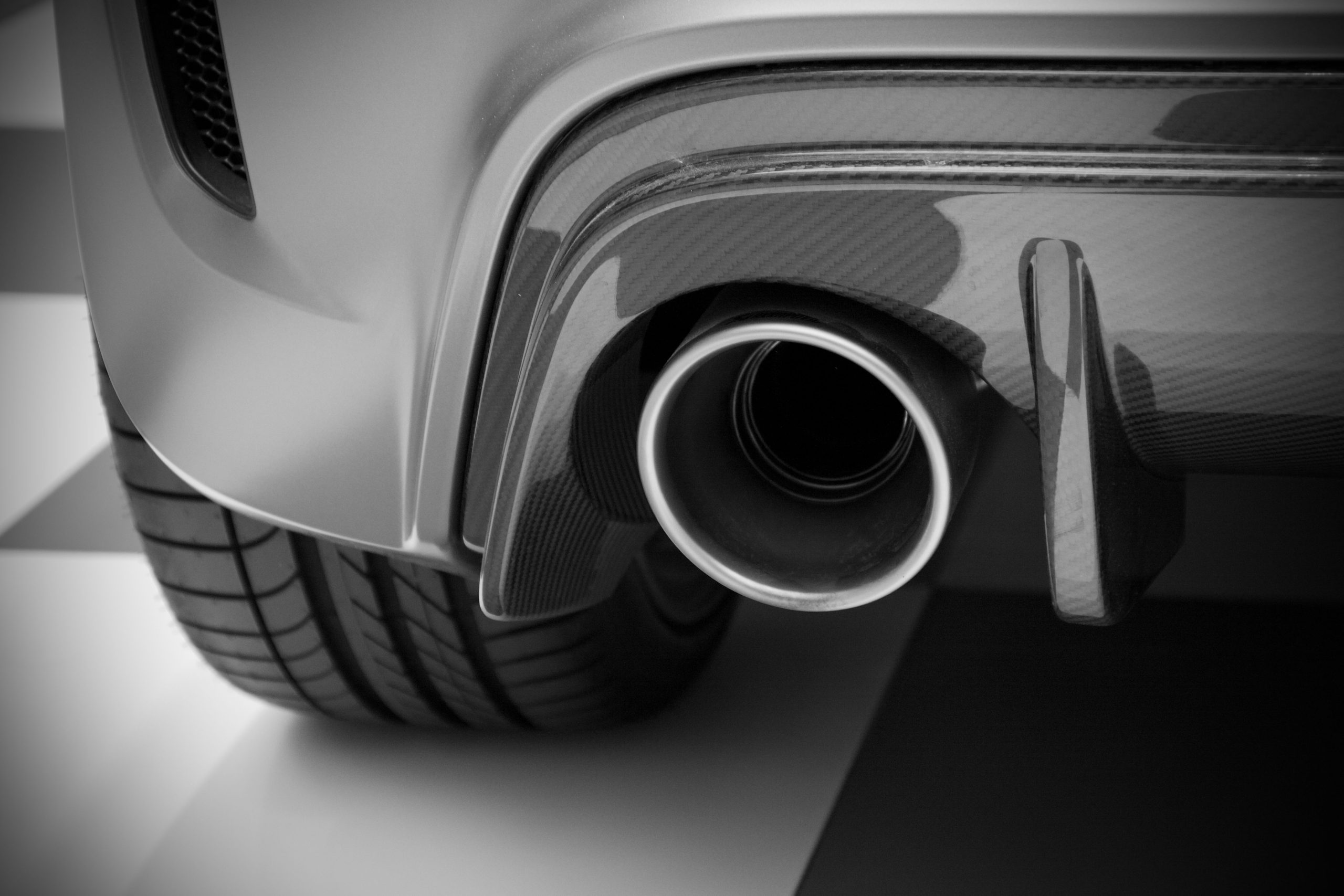 Black and white close-up of a vehicle exhaust pipe