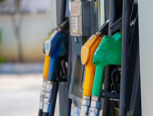 Close-up of colored fuel nozzles at a gas station showing different gasoline and diesel grades