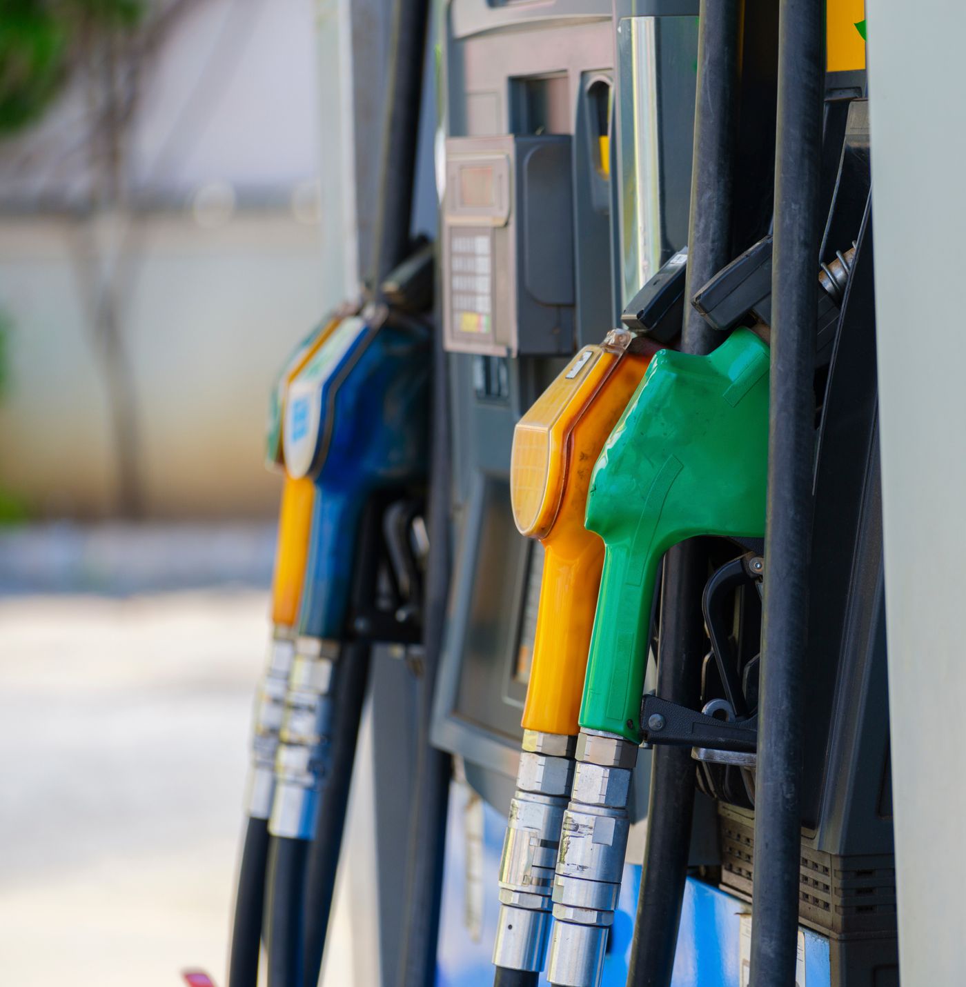 Close-up of colored fuel nozzles at a gas station showing different gasoline and diesel grades