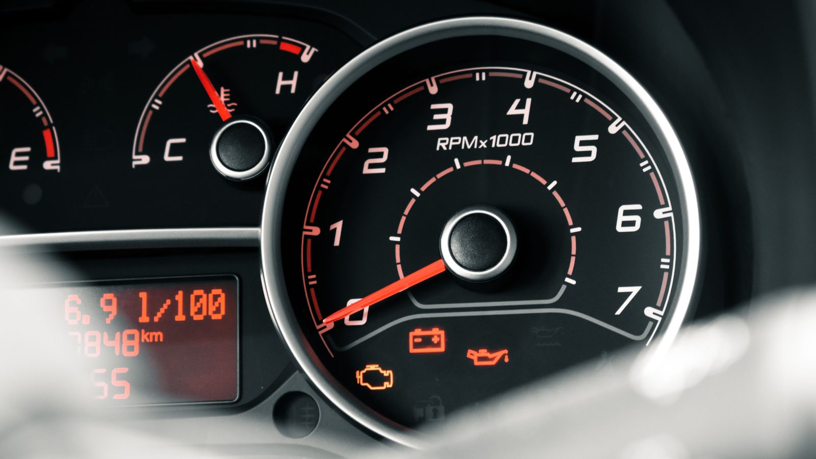 Close-up view of a car dashboard with instrument cluster and warning indicators