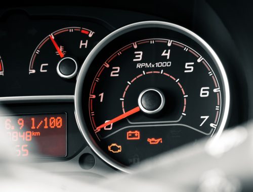 Close-up view of a car dashboard with instrument cluster and warning indicators