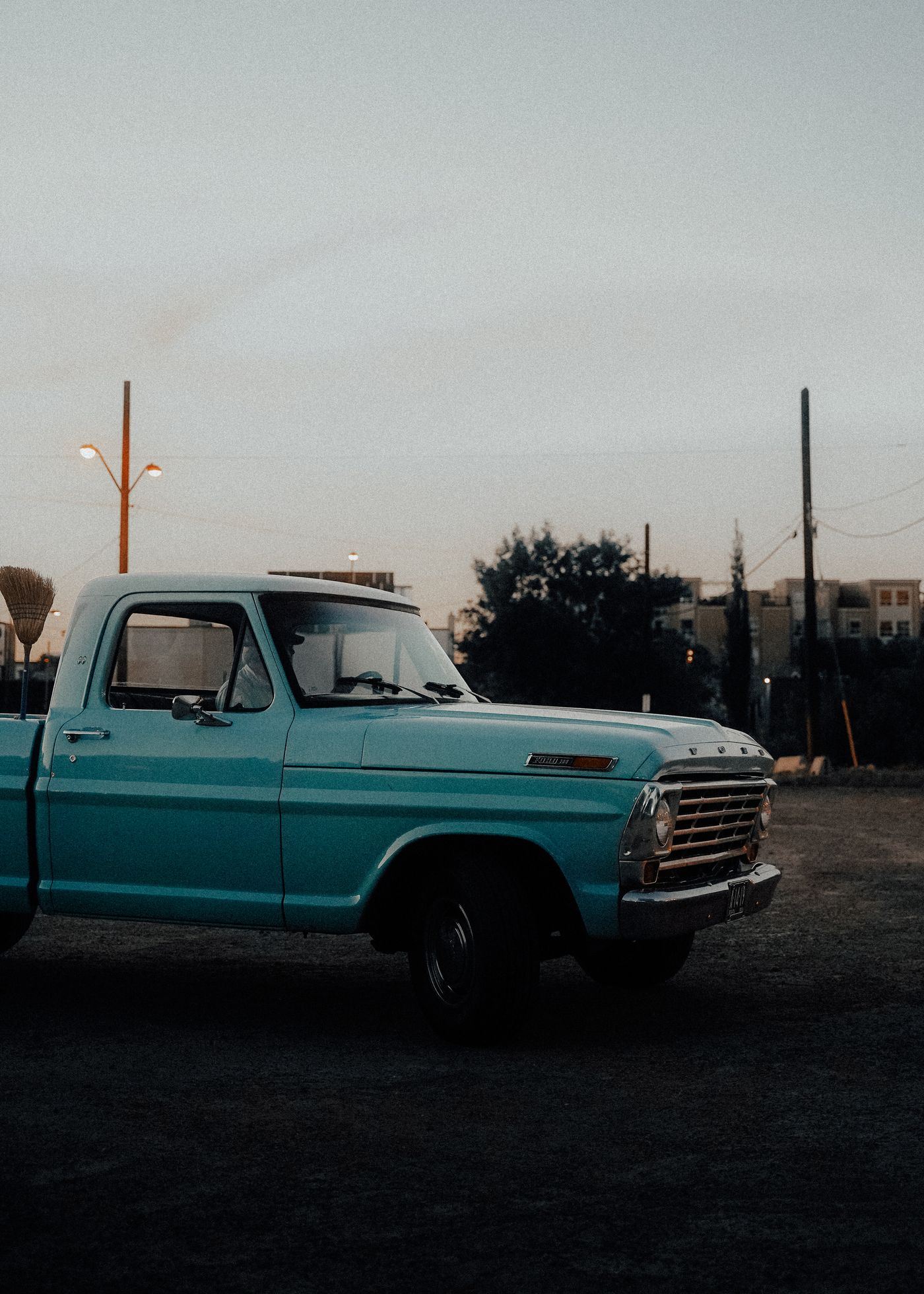 Full-size pickup truck parked on an open road, side profile view