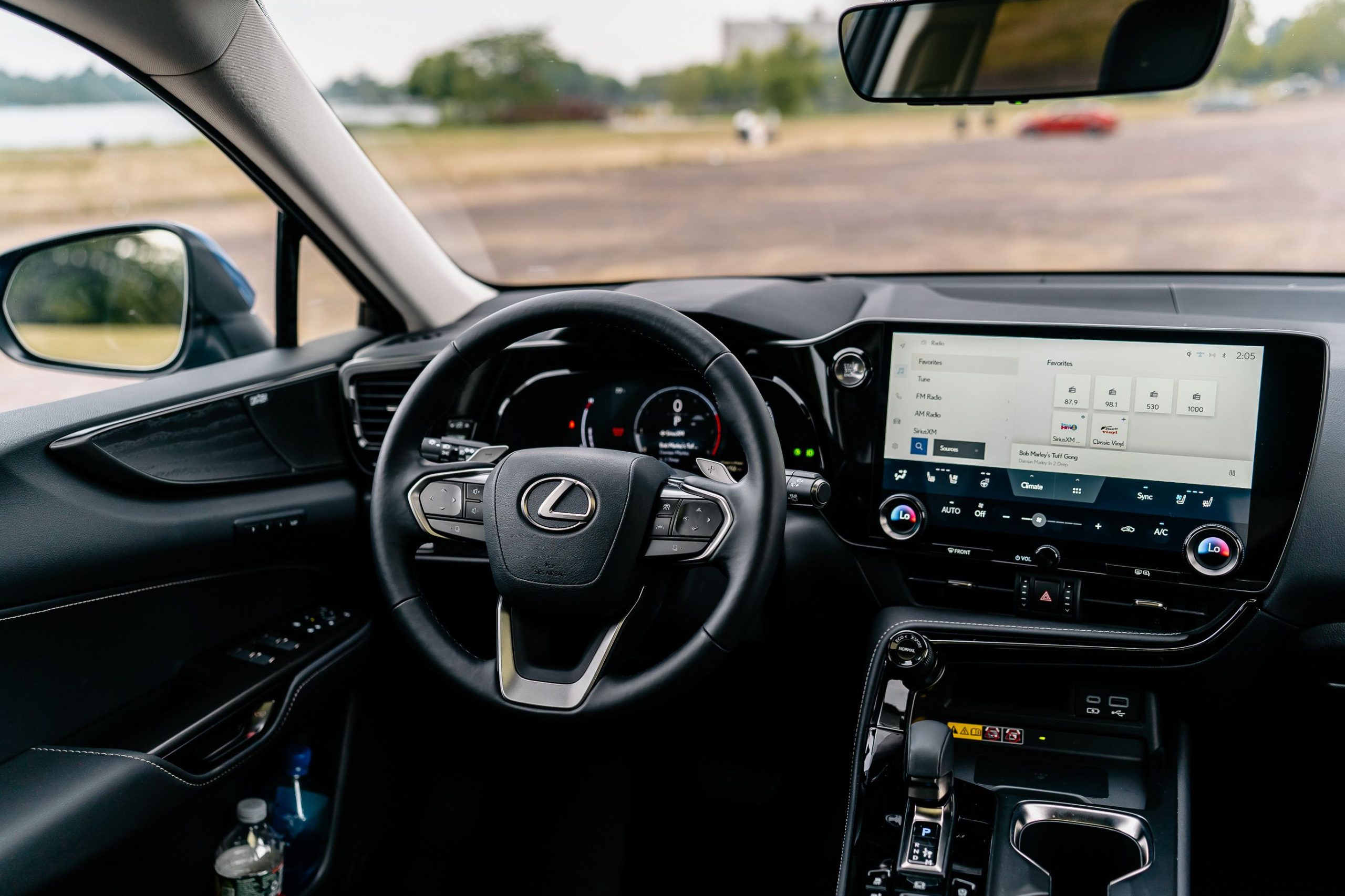 Close-up of a modern car steering wheel and touchscreen infotainment display
