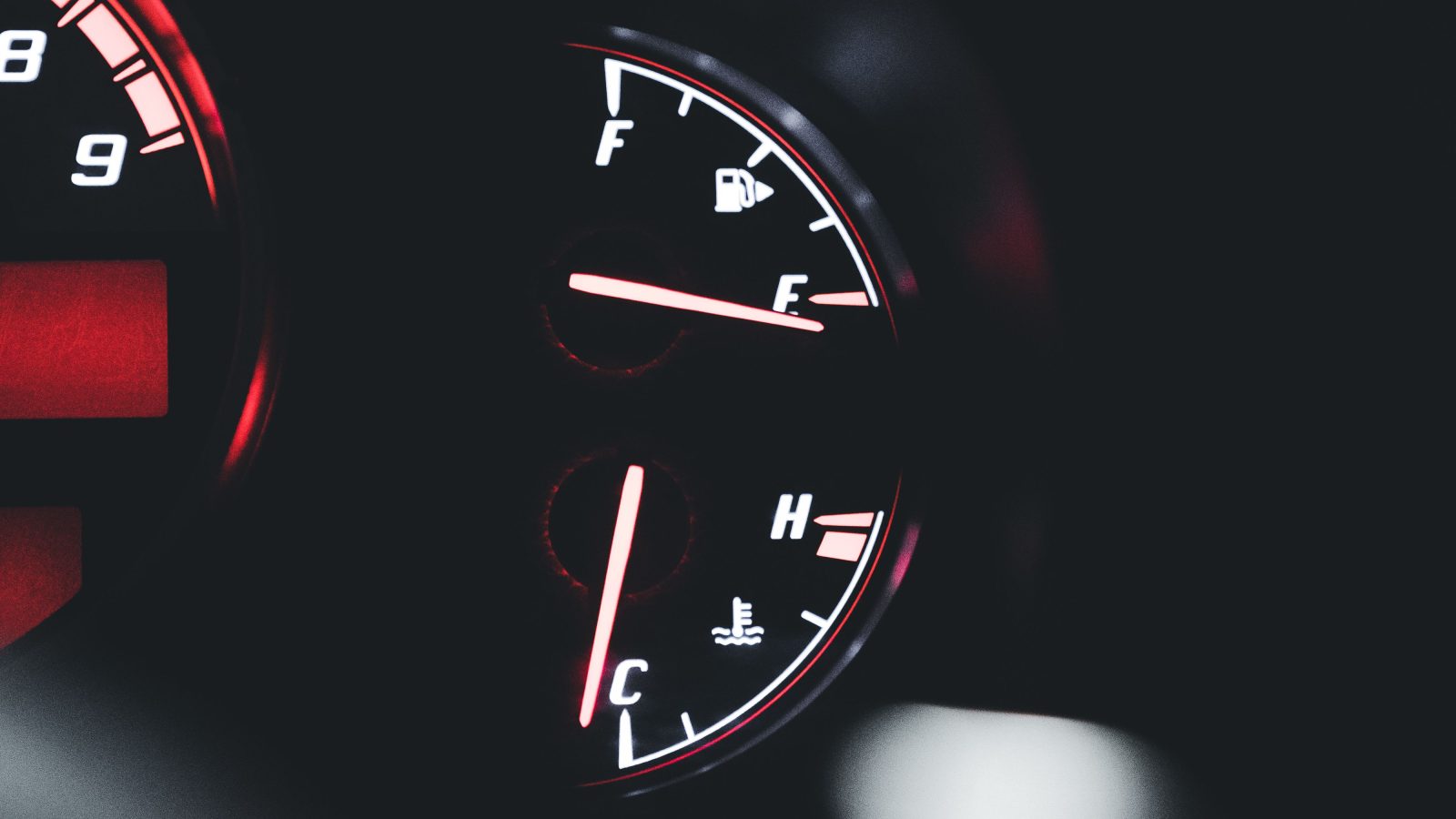 Close-up of a car dashboard showing temperature and fuel gauges