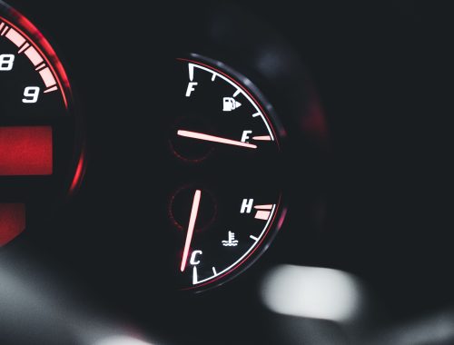Close-up of a car dashboard showing temperature and fuel gauges