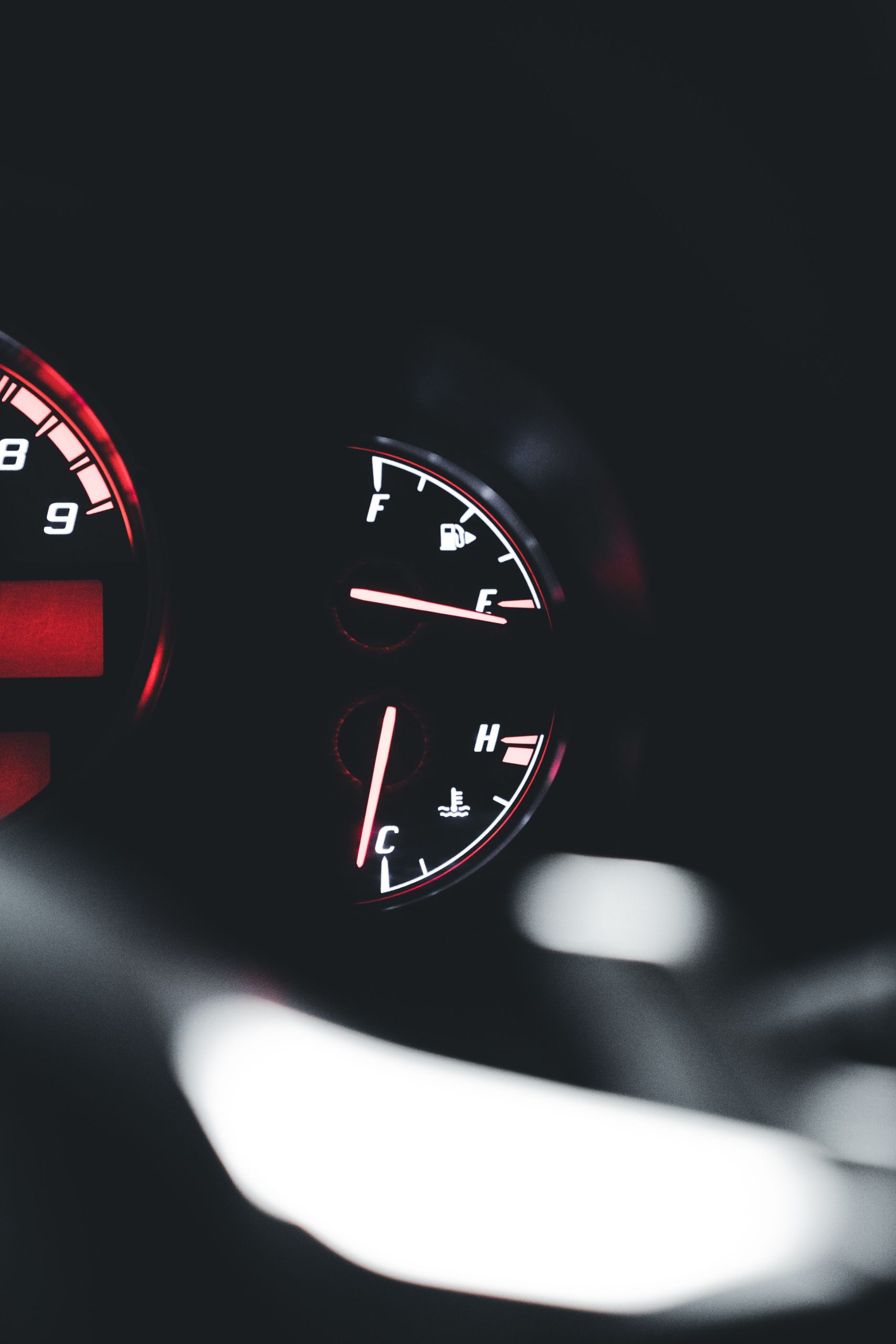 Close-up of a car dashboard showing temperature and fuel gauges