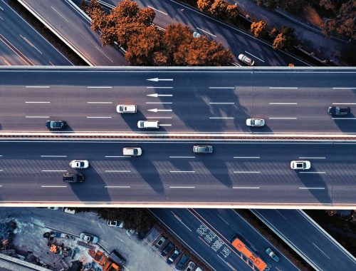 Multiple lanes of traffic on an elevated highway viaduct with no cross streets