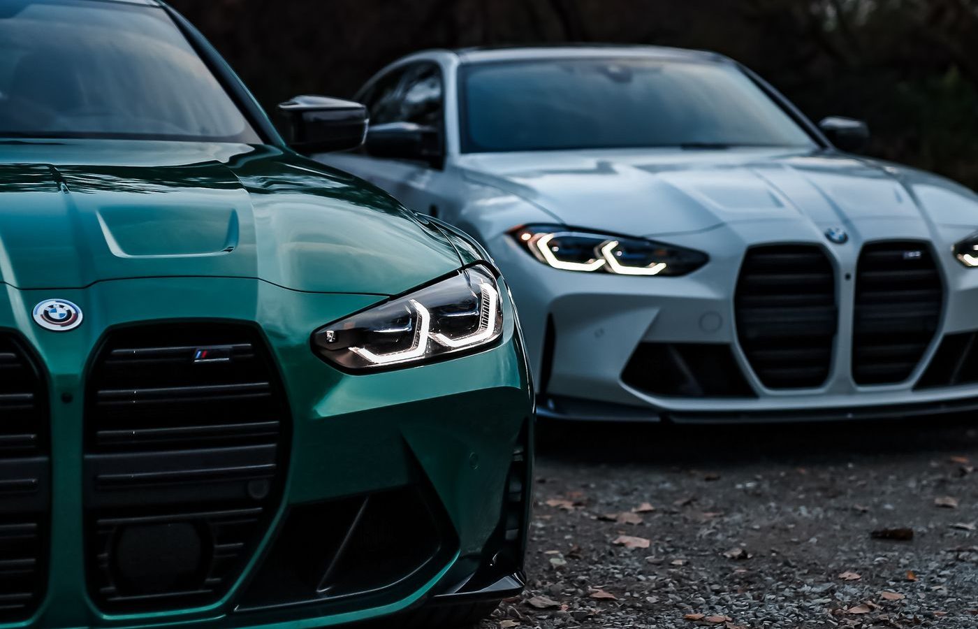 Two BMW M3 sedans parked side by side showing the twin-kidney grille