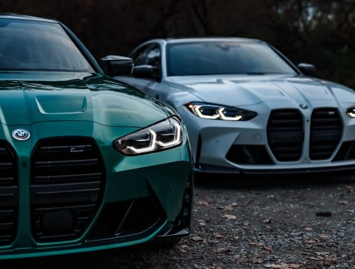 Two BMW M3 sedans parked side by side showing the twin-kidney grille