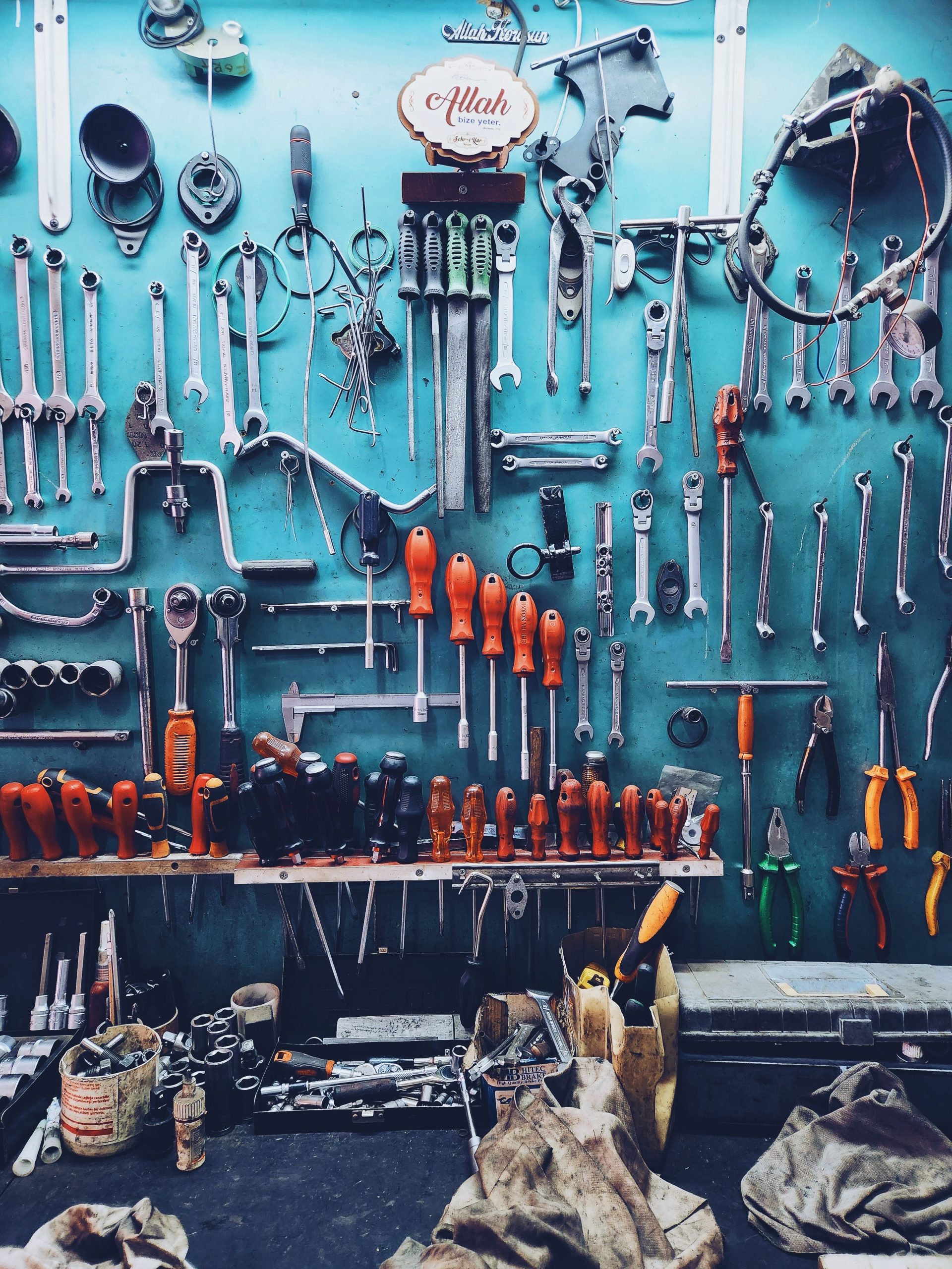 Sorted hand tools arranged on a workshop wall