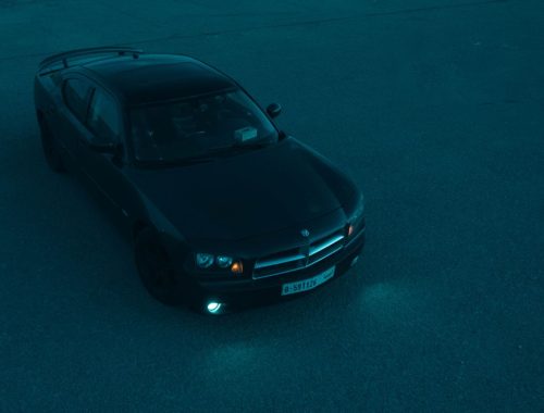 Black Dodge Charger photographed from above, parked at night