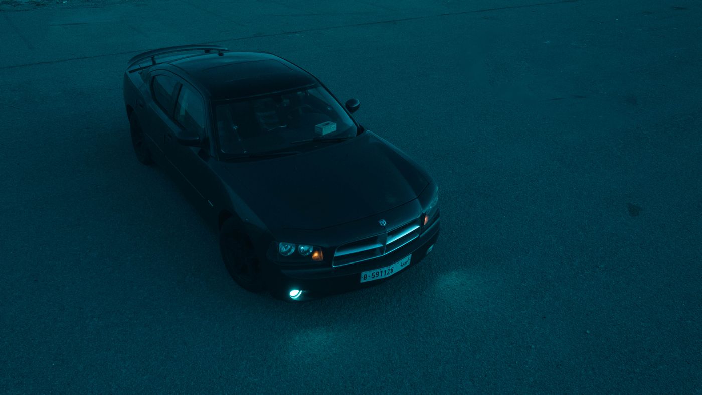 Black Dodge Charger photographed from above, parked at night