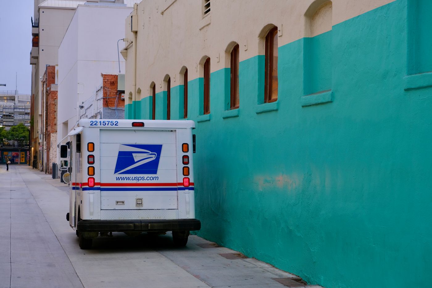 White box truck parked in front of a wall, the type of commercial vehicle typically fully wrapped for branding