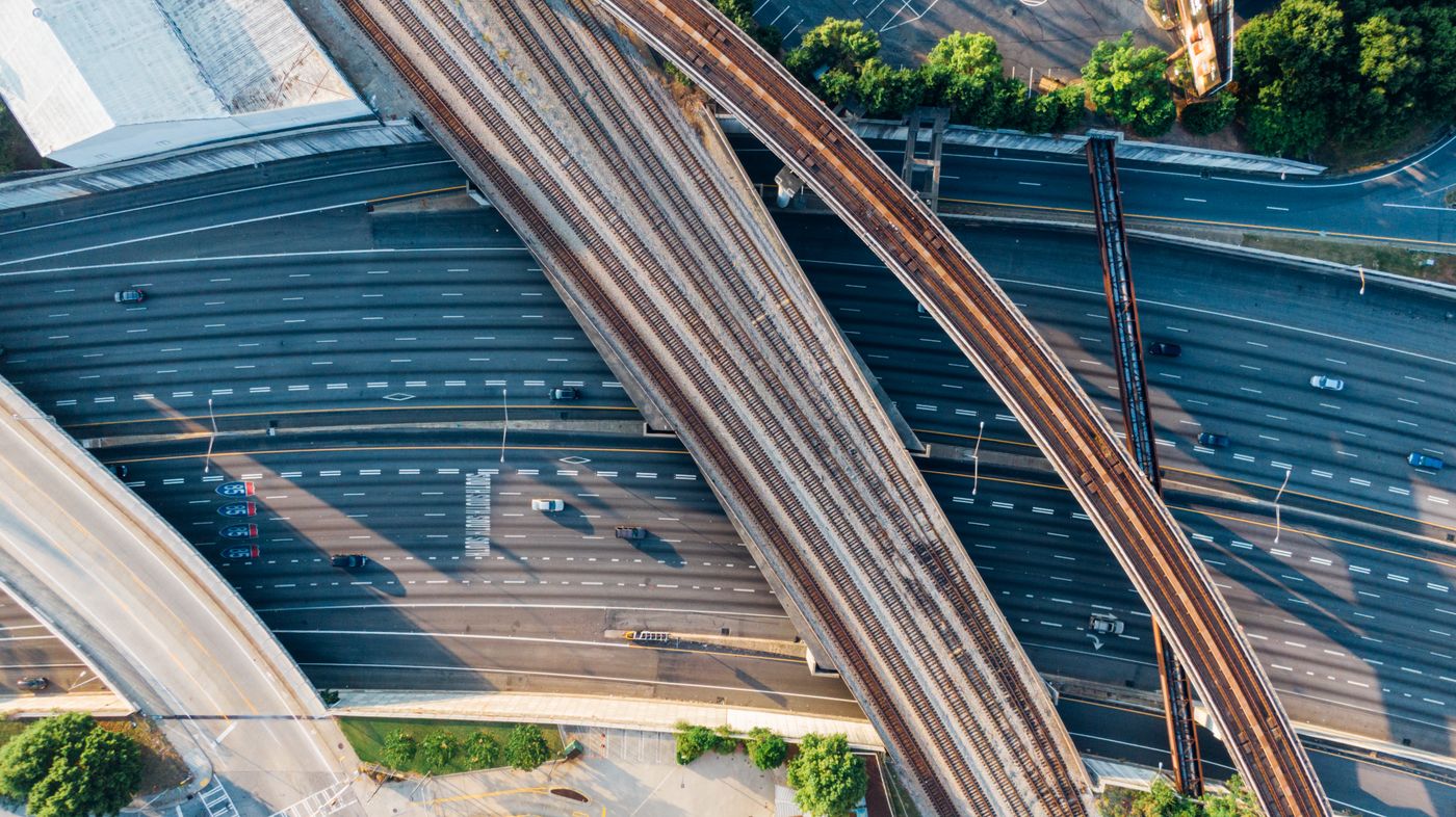 Aerial view of a multi-lane roadway with grade-separated interchange ramps