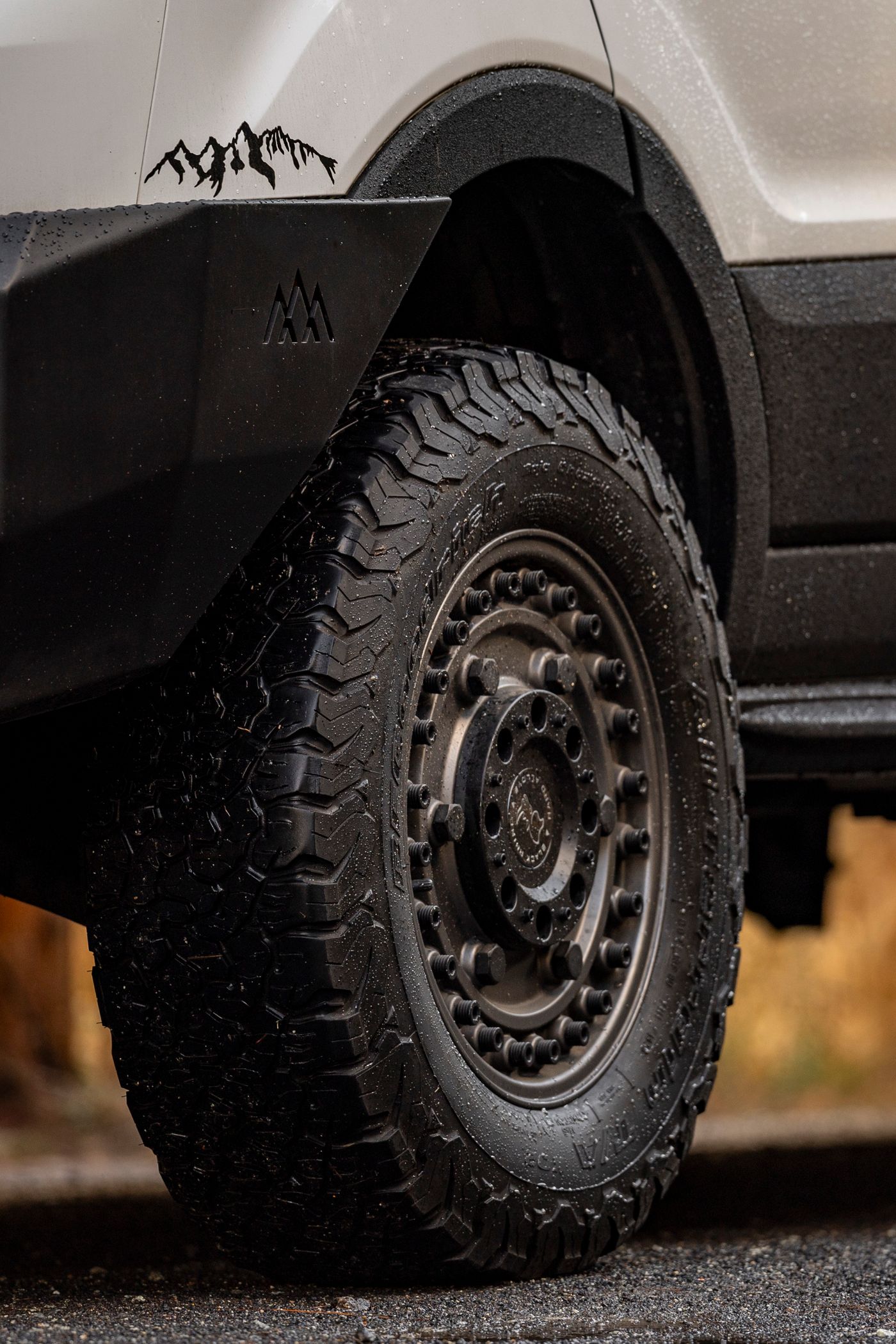 Close-up of a large off-road tire with aggressive tread pattern