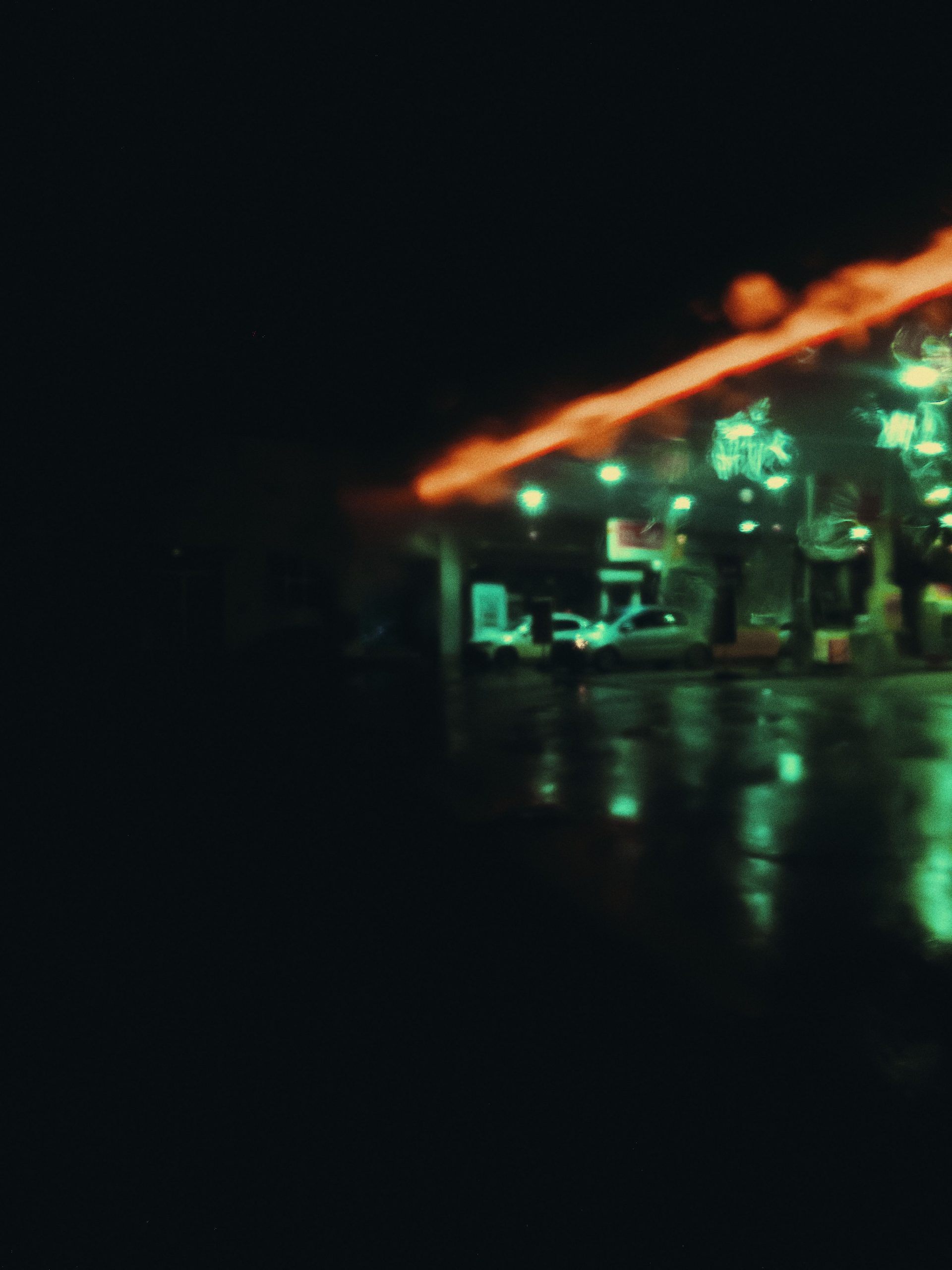 Cars parked on the street at night under streetlights