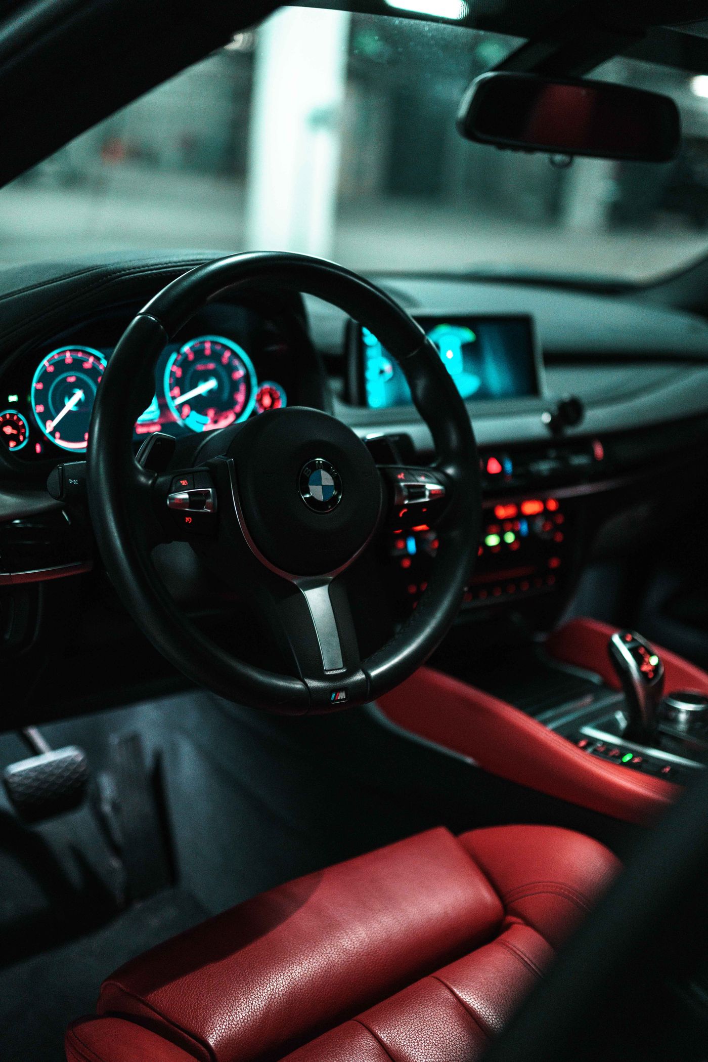 Black and red car interior with illuminated dashboard