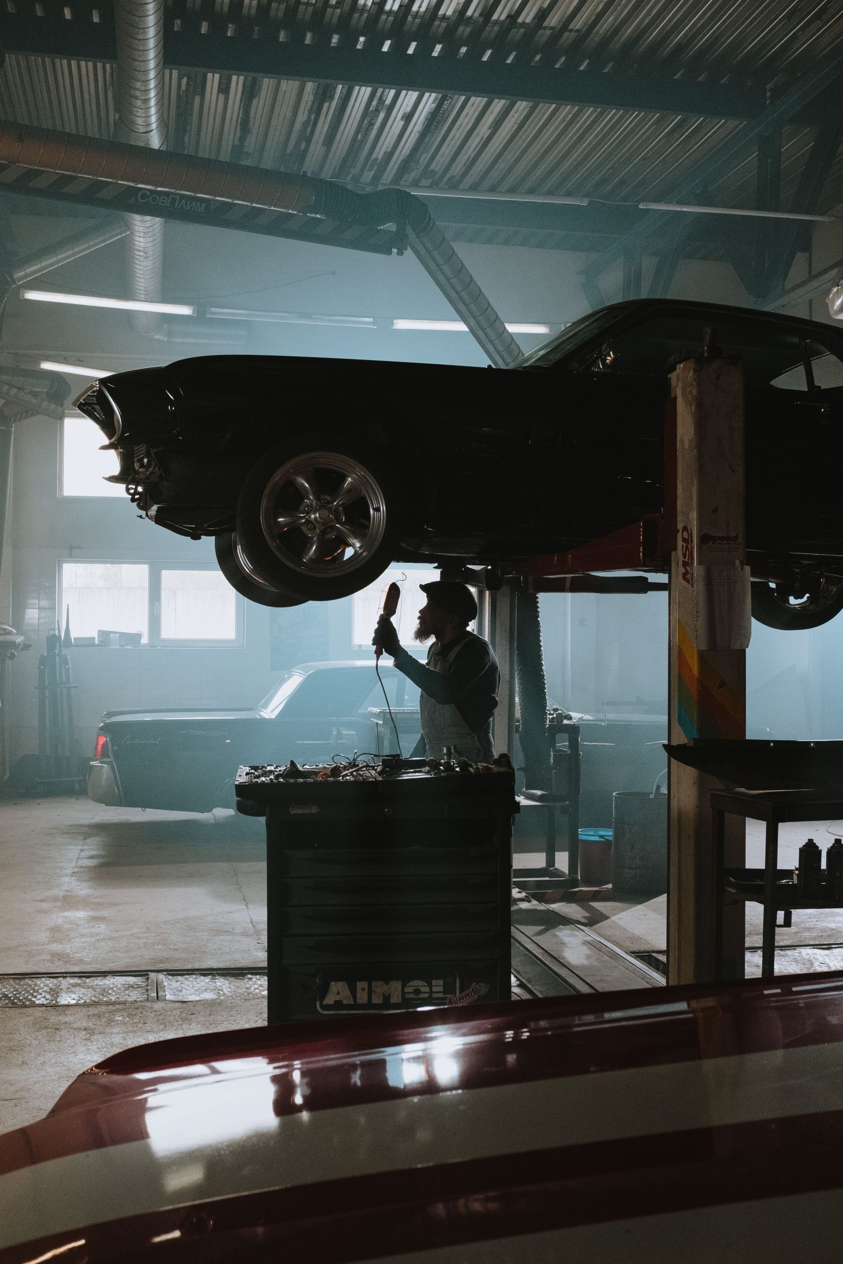 Close-up of a car wheel on a lift in an automotive garage