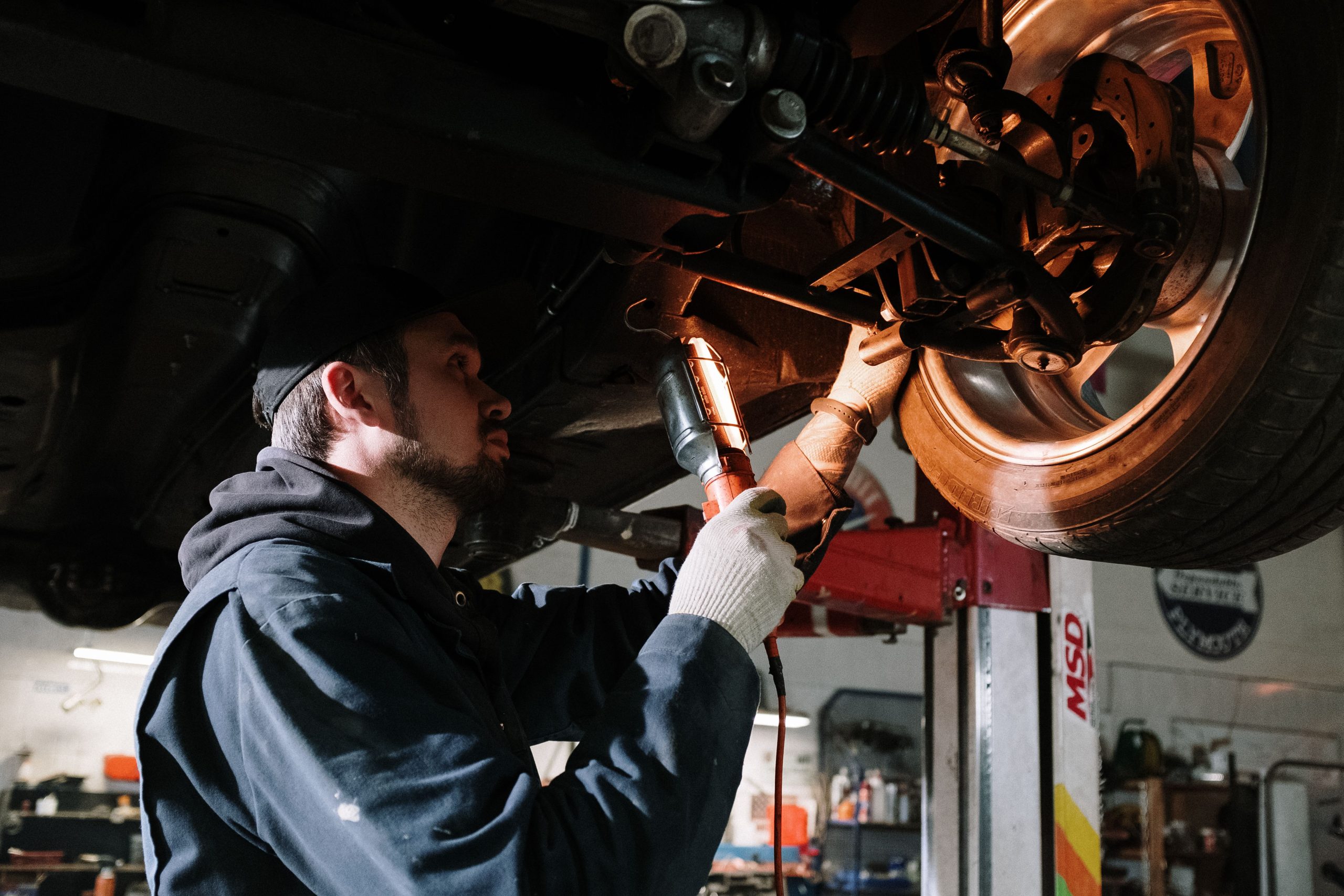 Mechanic working on car battery terminals