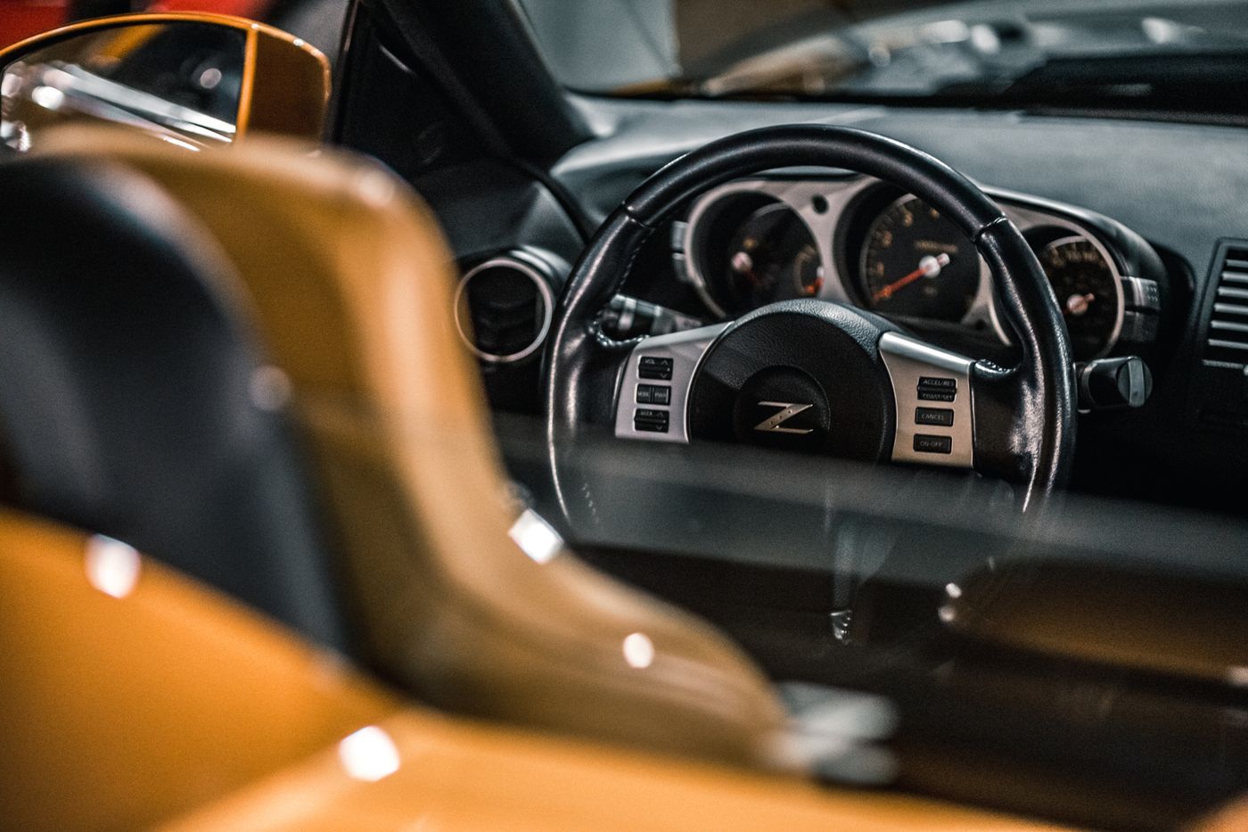 Interior of a performance car showing the dashboard, steering wheel, and gauge cluster