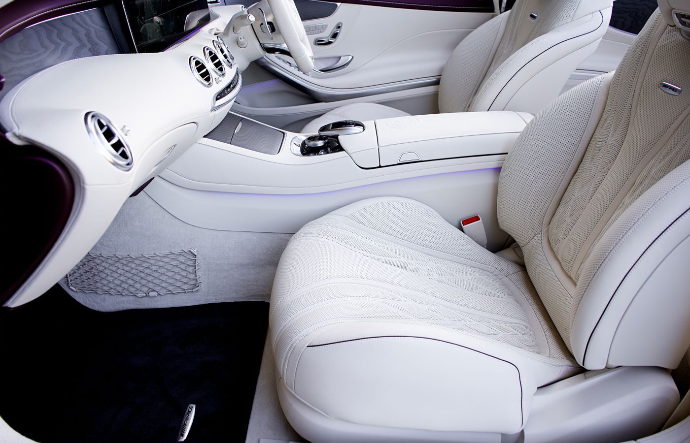 Car interior with clean white leather seats and dashboard, the source of new car smell