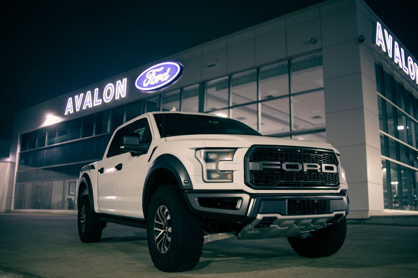 White pickup truck parked near a storefront, a common candidate for a partial or full wrap