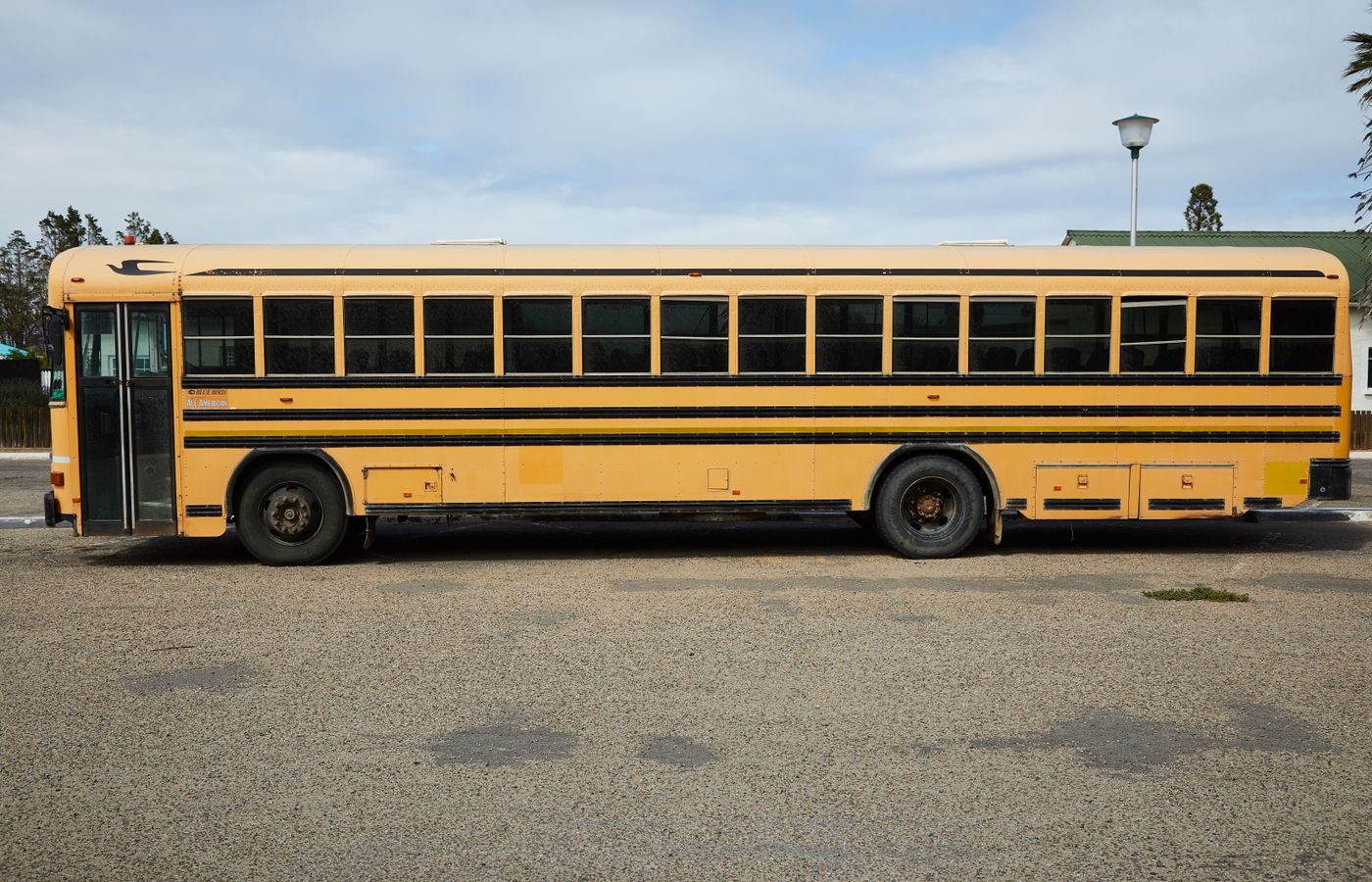 Yellow school bus parked, the type of vehicle required to stop at every railroad crossing