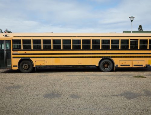 Yellow school bus parked, the type of vehicle required to stop at every railroad crossing