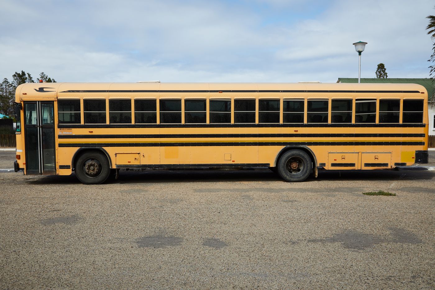 Yellow school bus parked, the type of vehicle required to stop at every railroad crossing