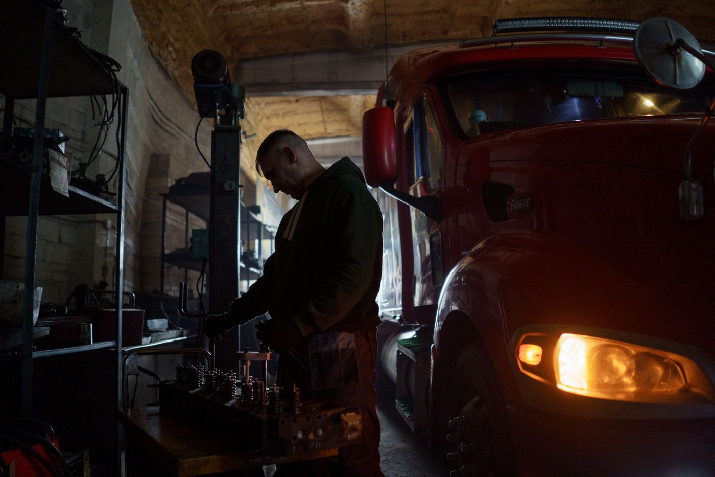Mechanic working underneath a truck, the kind of labor involved in a lift kit installation