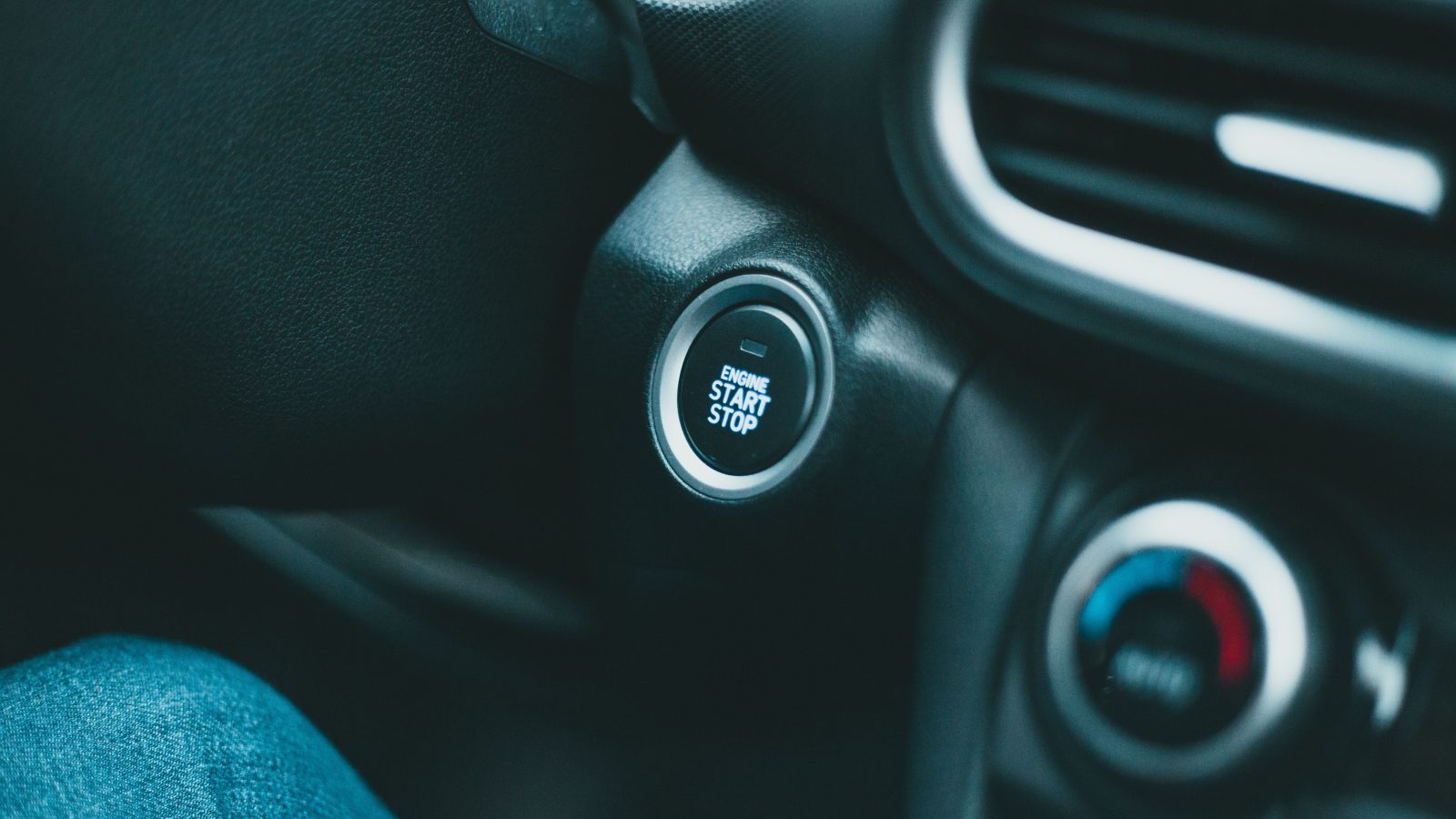Close-up of a modern car interior with engine start button