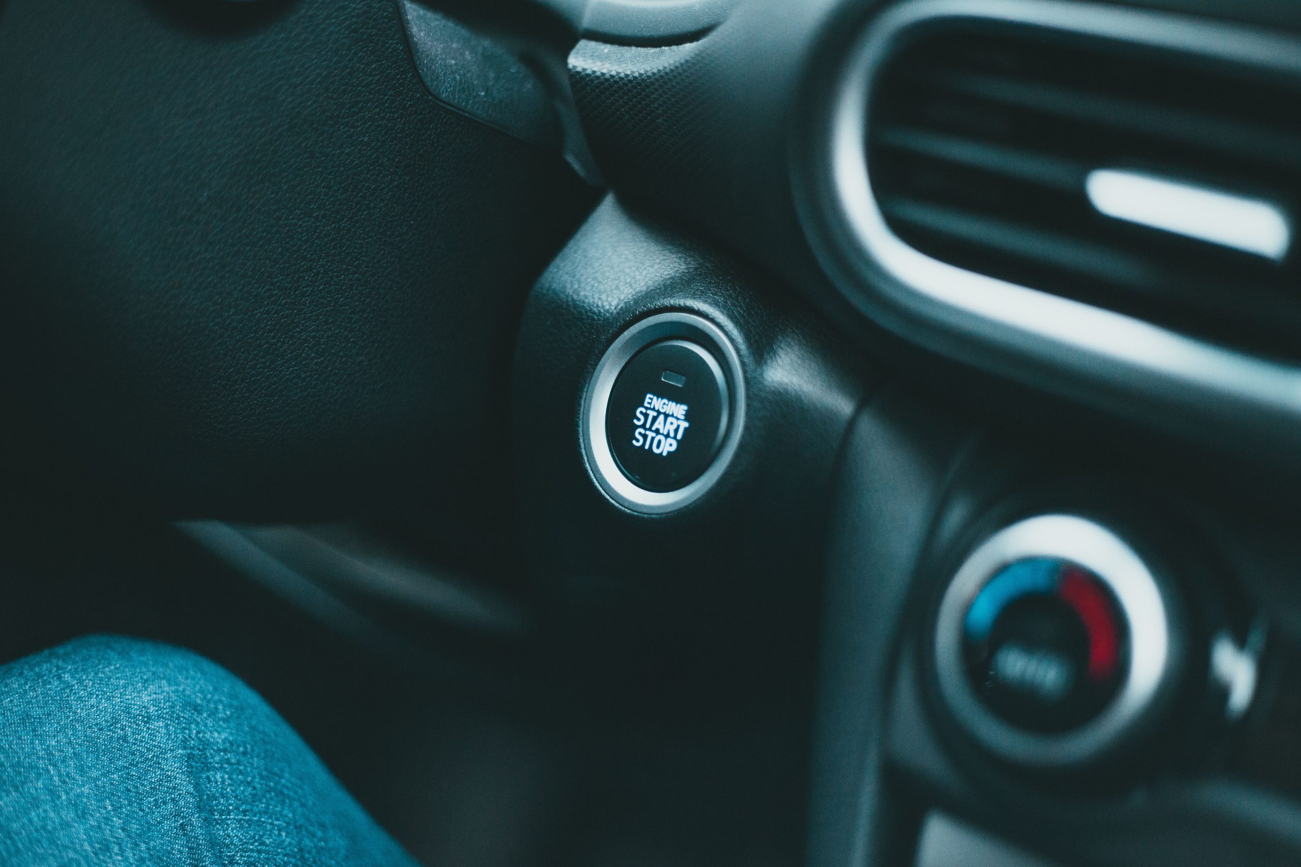 Close-up of a modern car interior with engine start button