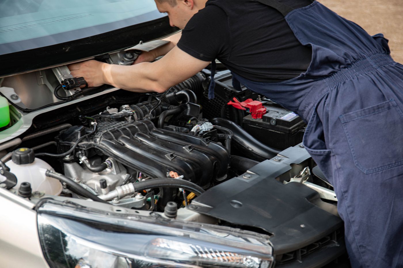 Mechanic working underneath a raised vehicle on suspension components