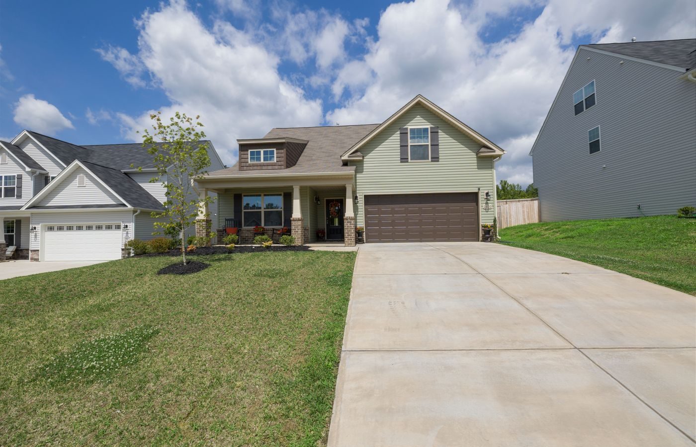 Modern suburban detached house with a wide driveway leading to an attached garage