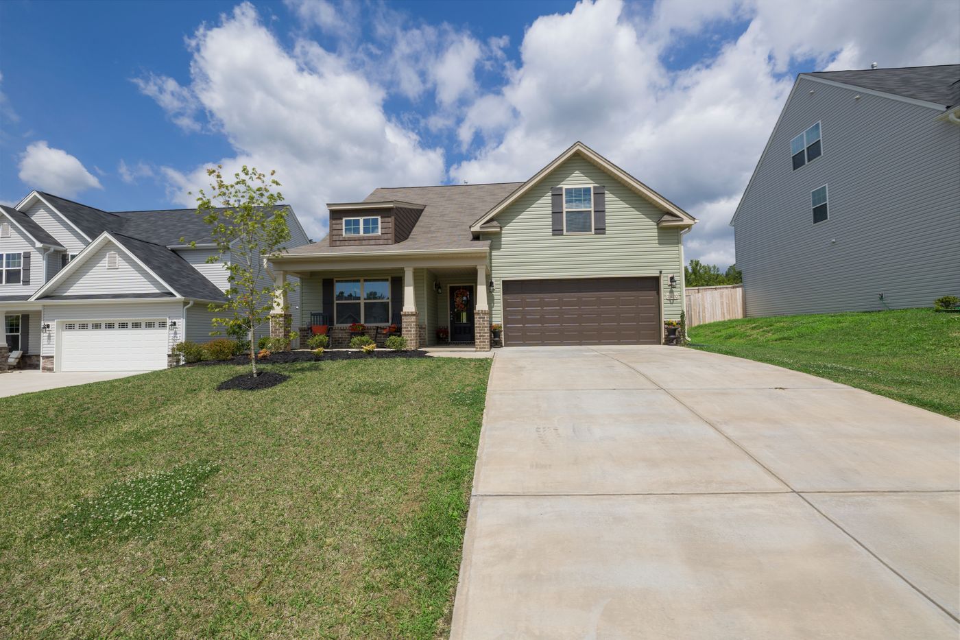 Modern suburban detached house with a wide driveway leading to an attached garage
