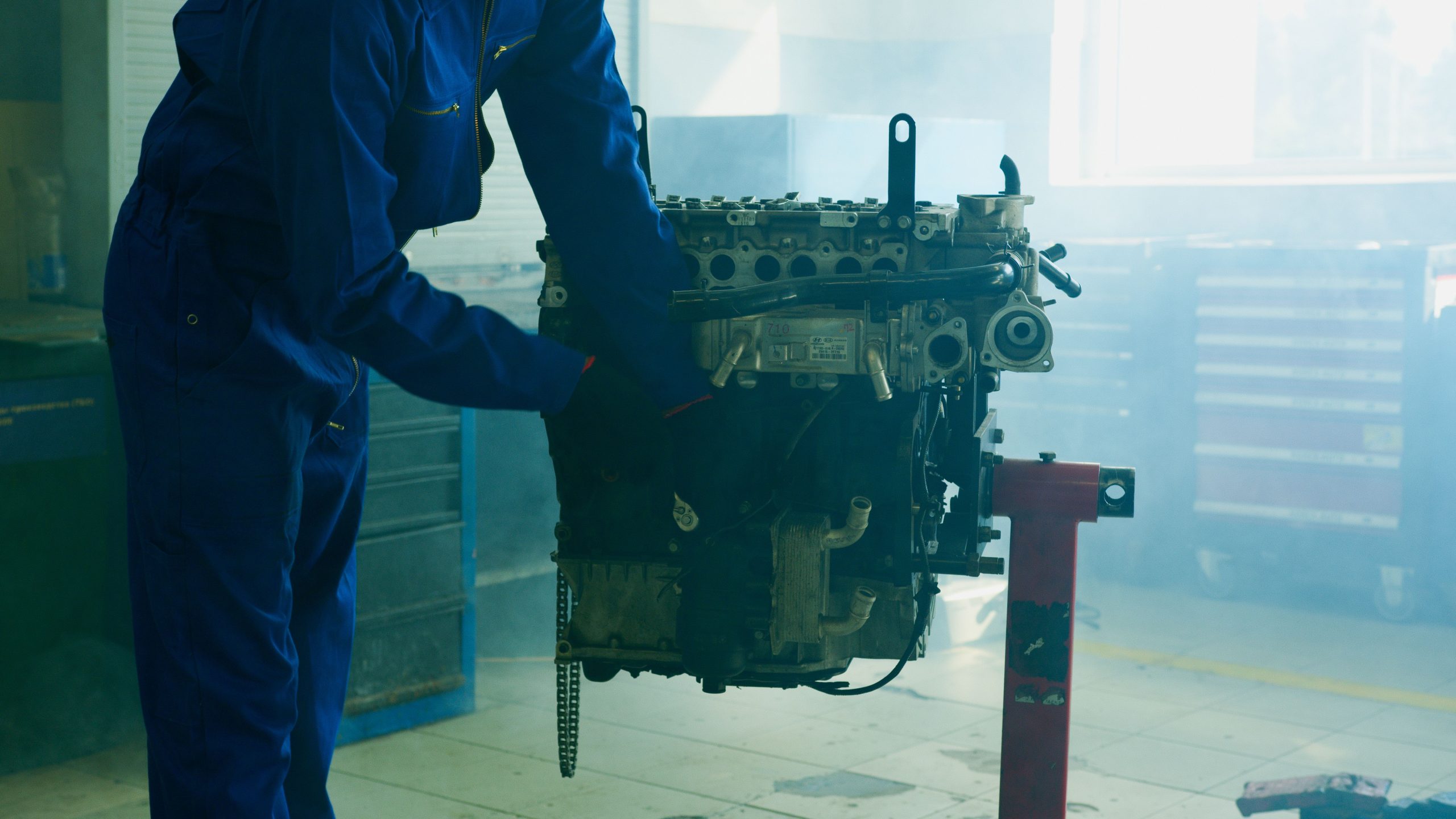 Mechanic fixing a car engine in a garage