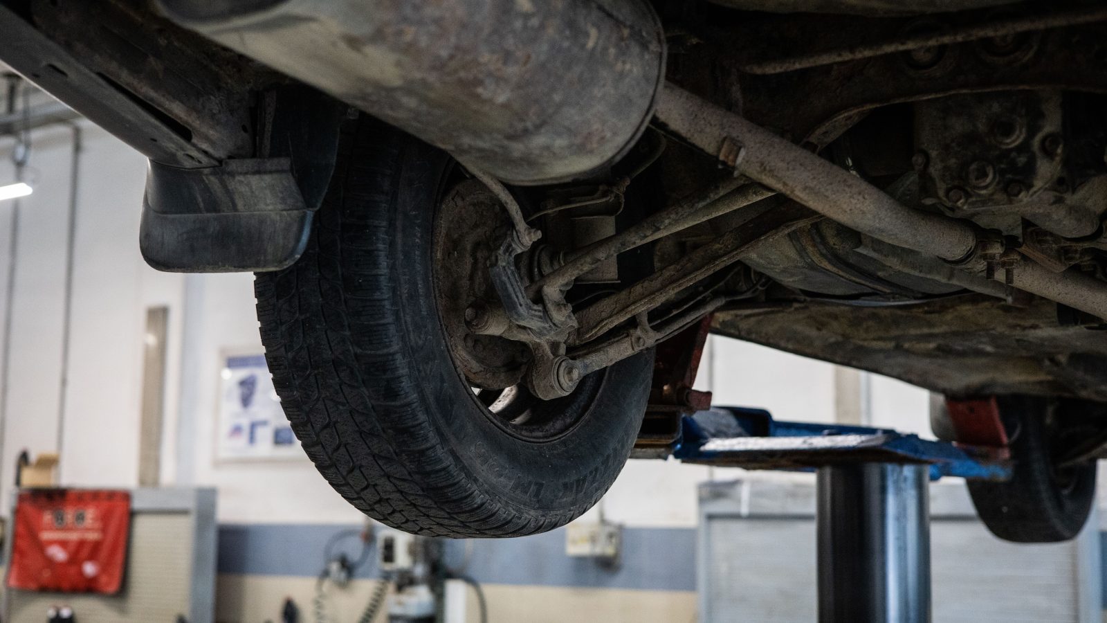 View of a car's underside showing the axle and suspension components