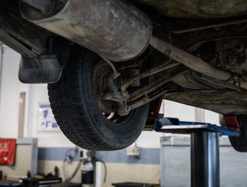 View of a car's underside showing the axle and suspension components