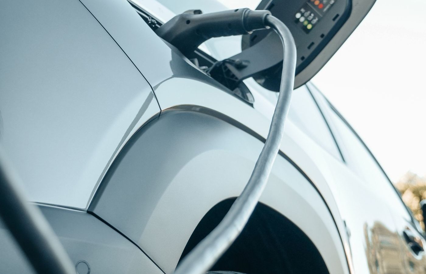 Electric car plugged into a Level 2 charging cable at home