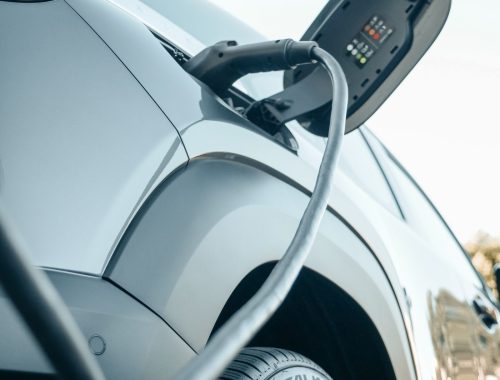 Electric car plugged into a Level 2 charging cable at home