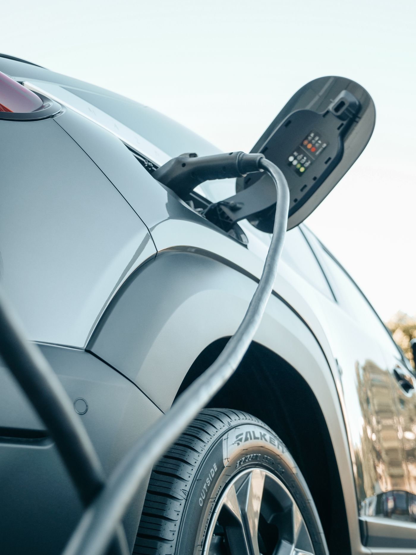 Electric car plugged into a Level 2 charging cable at home