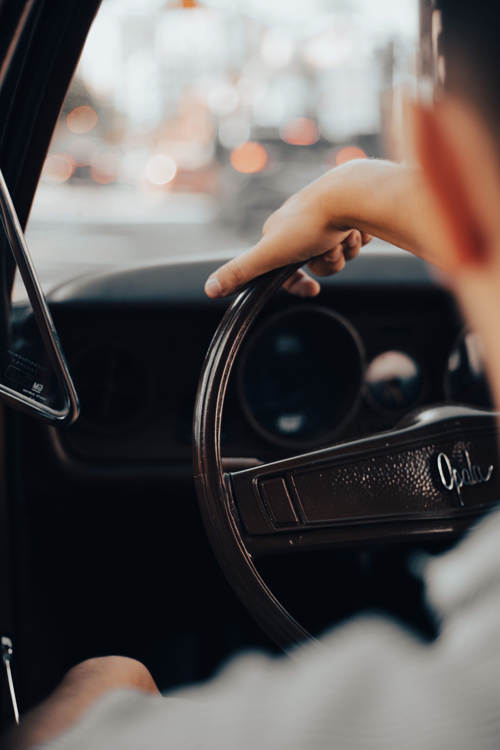 Close-up of a hand on a steering wheel