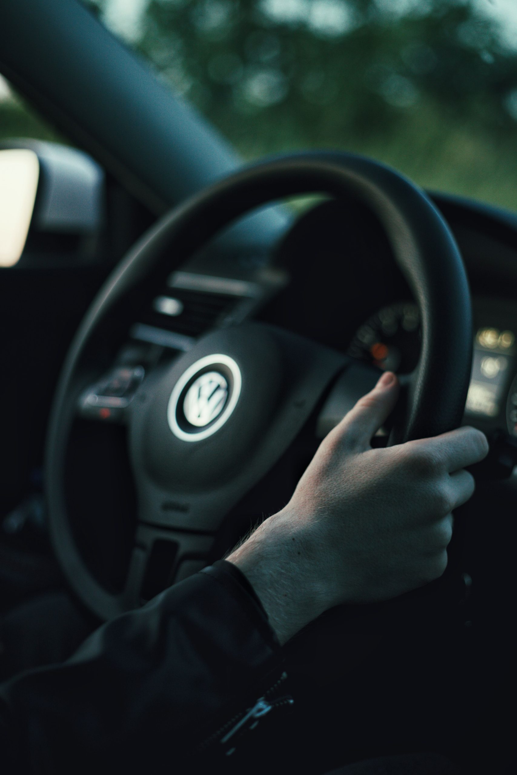 Hands holding a leather steering wheel