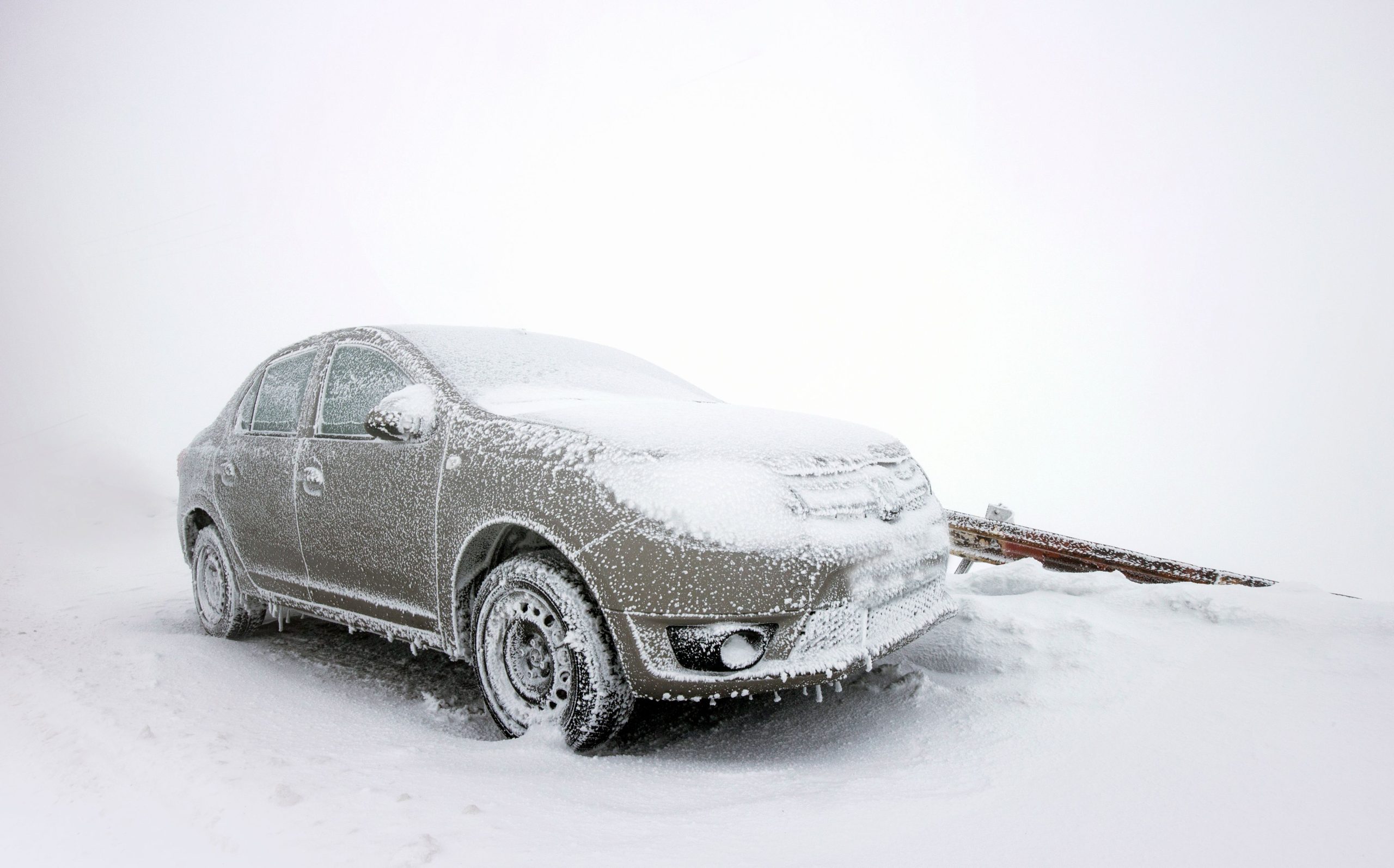 Frozen car on snow-covered ground