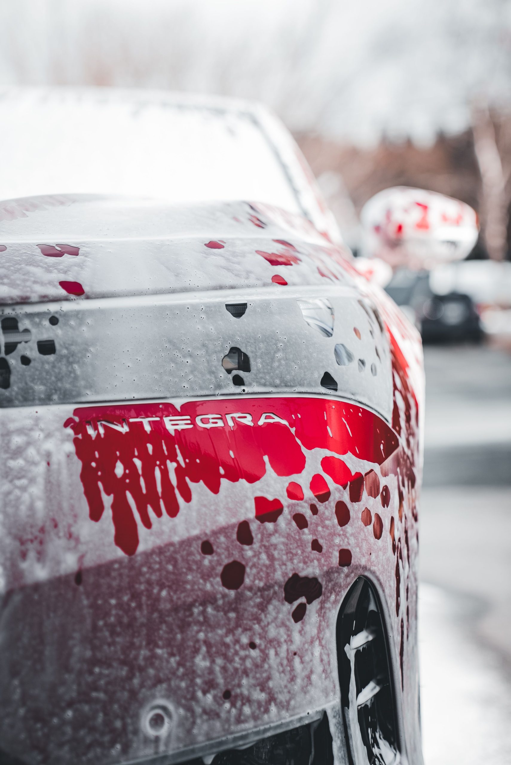 Foam-covered car exterior during a wash
