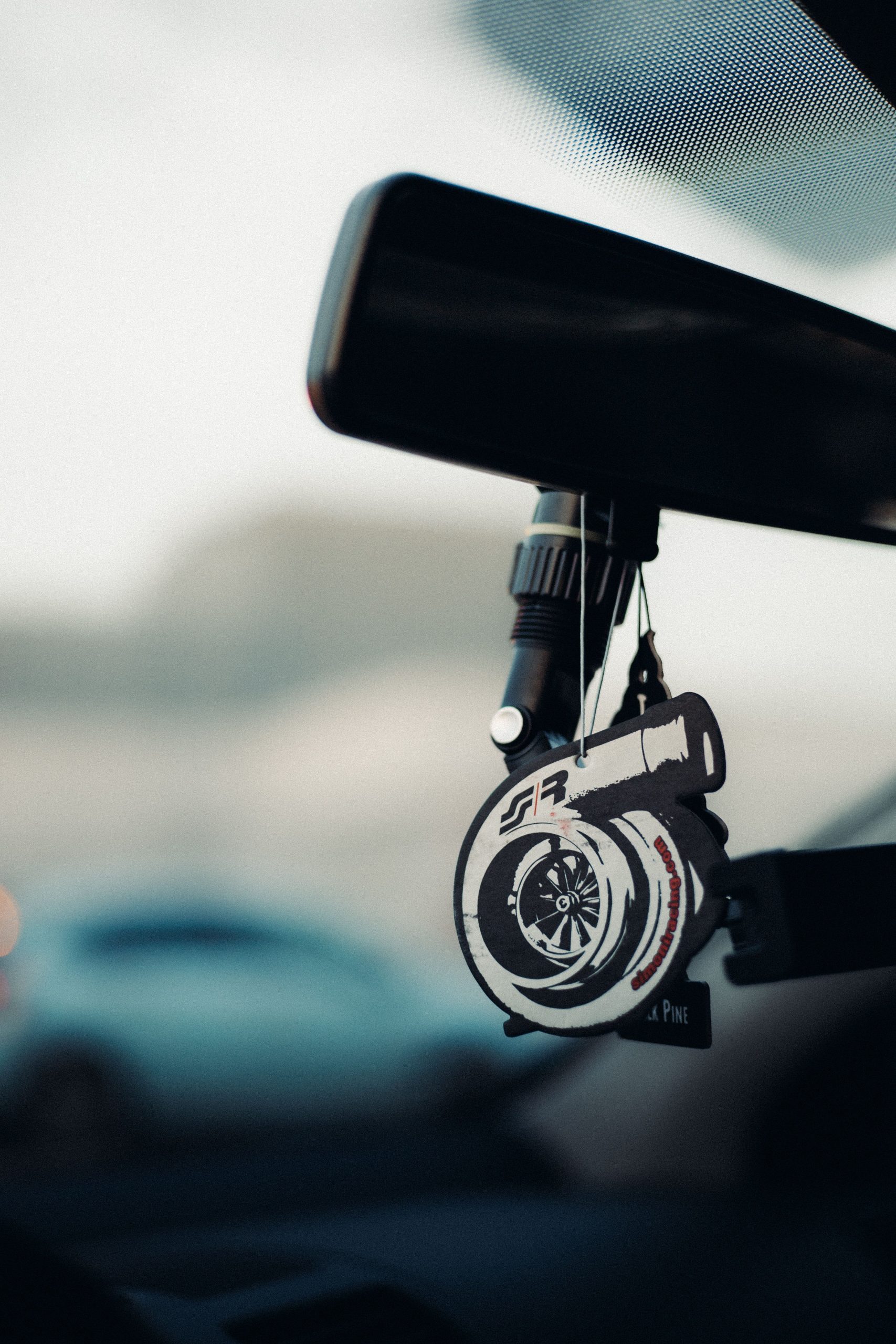 Car air freshener charm on rearview mirror